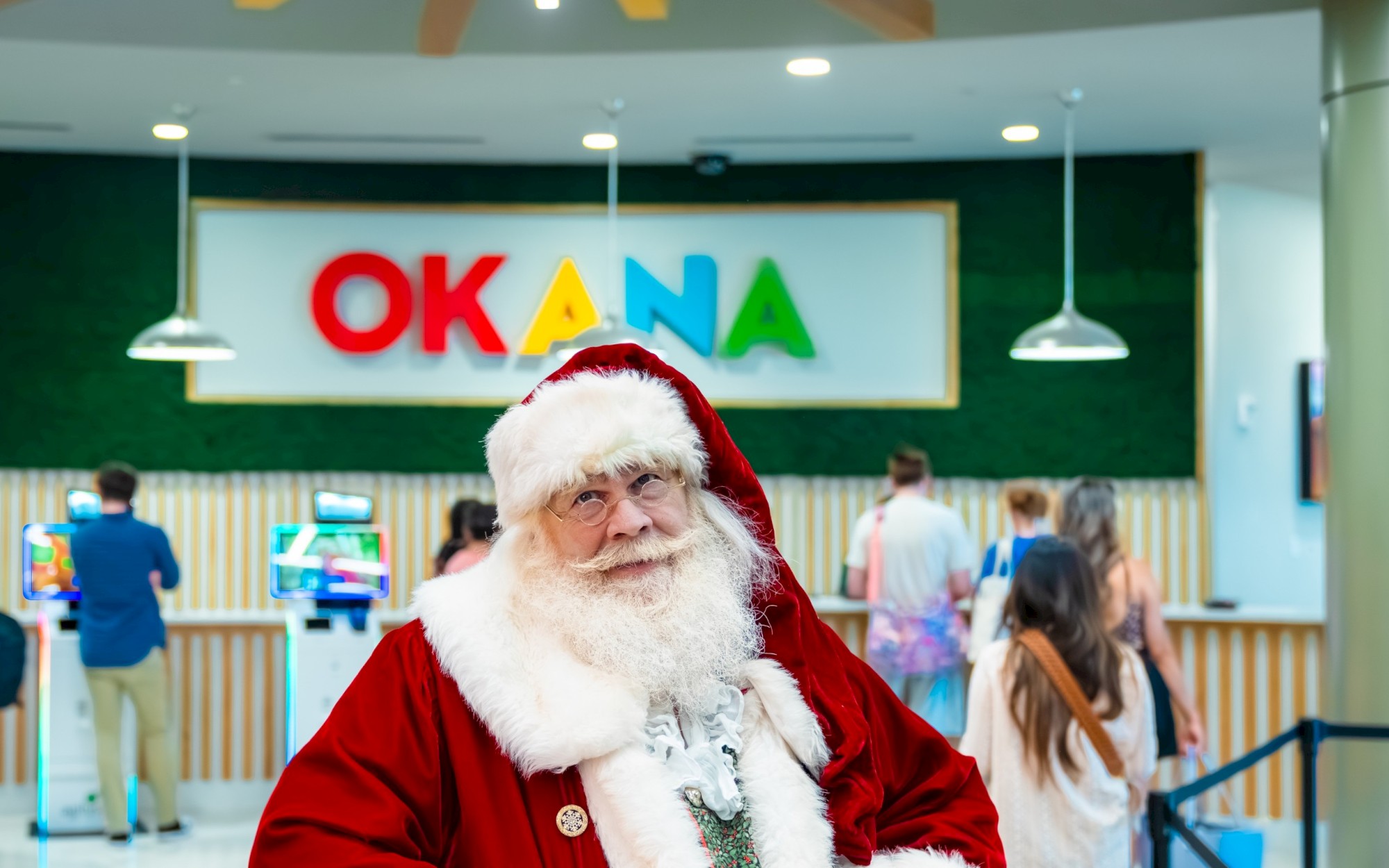 Santa at the front desk of OKANA Resort and Indoor Waterpart. He is on his way to enjoy the Christmas Day Buffet for family restaurant dining in OKC.