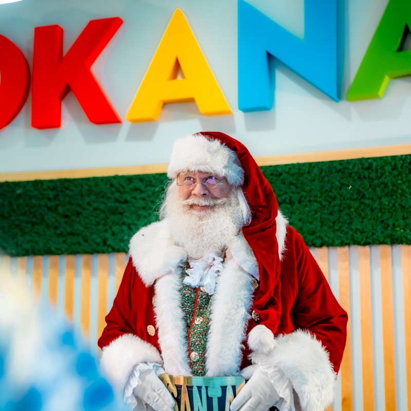 Santa checking in guests at okana resort on Christmas Day. He's about to head to the Christmas Buffet and visit OKC restaurants open on Christmas day.