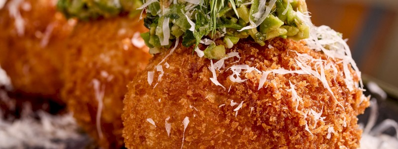 Fried Risotto (V) - Golden brown fried parmesan risotto, smoked tomato jam, castelvetrano olive tapenade