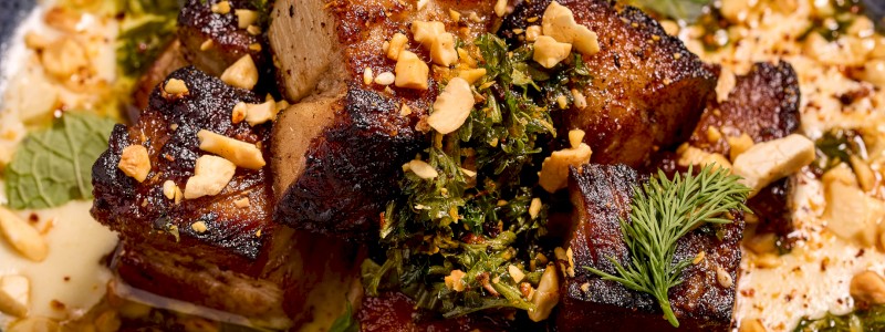 Braised Pork Belly - 6 oz braised pork belly, fennel soubise, orange & mint gremolata, cashew dukkah, herbs