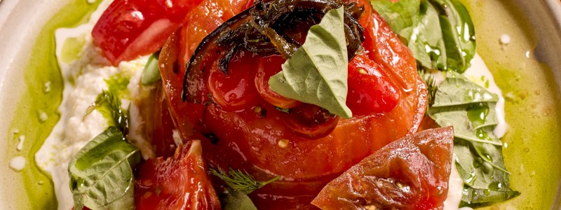 Marinated Heirloom Tomato Salad (GF/V) - Marinated heirloom tomato, truffle stracciatella cheese, pepper jam, basil, oregano