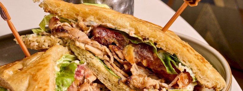 Pork Belly BLT - House made focaccia, braised pork belly, mayo, lettuce, marinated tomato, gremolata