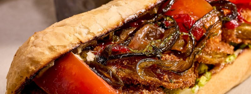 Fried Green Tomato Poboy (V) - Fried green tomato, lettuce, marinated tomato, old bay tartar sauce, pepper jam