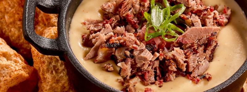 Brisket Queso - White cheddar served with tortilla chips Add pork rinds +6