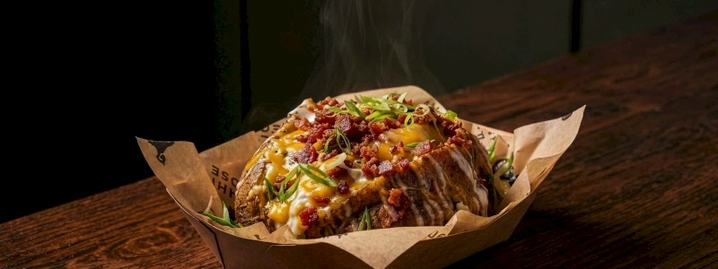 Basic Betty - Topped with bacon, butter, green onion, cheddar cheese, and sour cream