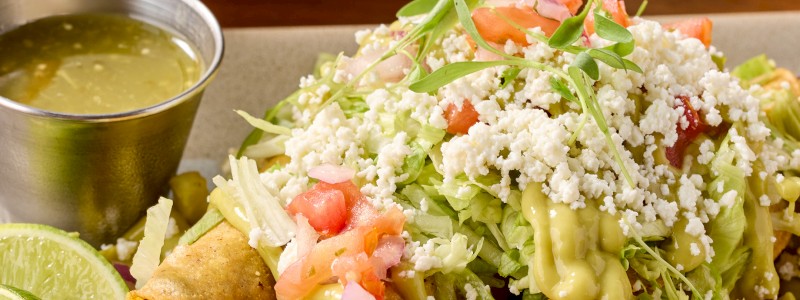 Braised Beef Flautas - Shredded beef, ancho chile peppers, avocado crema,
and shaved lettuce