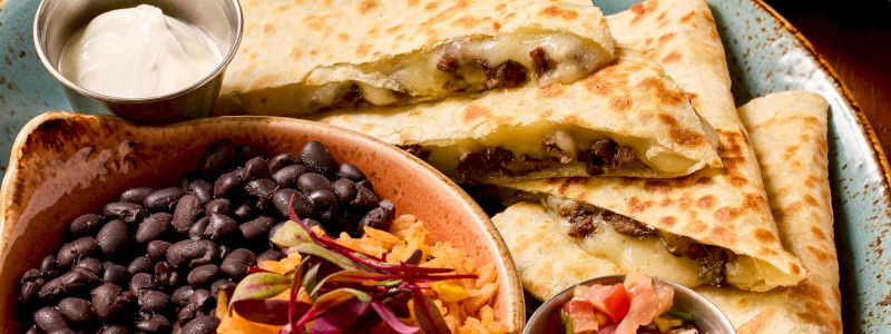 Chicken Poblano Quesadilla - Pulled chicken, three cheeses, poblanos, and corn,
served with pinto beans and Mexican rice