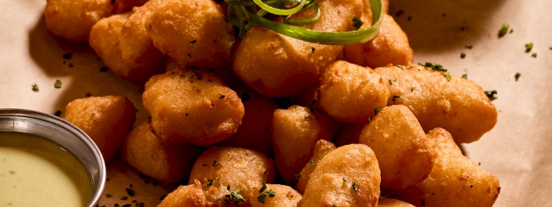 Fried Cheese Curds - Golden Wisconsin curds with pomegranate
molasses sauce
