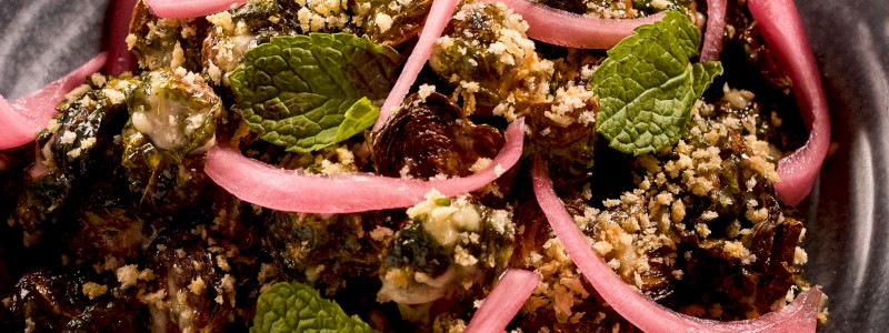 Bullseye Brussels - Crispy brussels sprouts, Caesar, pickled red onions,
toasted panko, and fresh mint