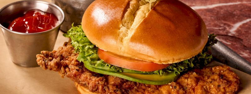 Axed Chicken Sandwich - Aleppo mayo, lettuce, tomato, onion, and avocado in a
brioche bun