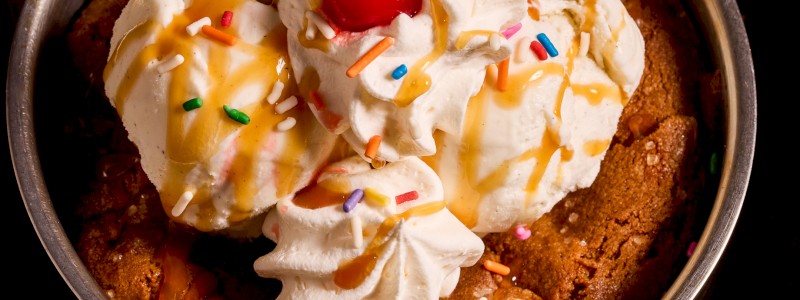 Cookies & Cream - Salted chocolate chip cookie skillet with vanilla bean
ice cream, topped with Bacardi rum sauce