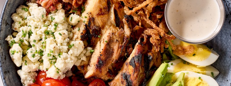 JAMAICAN JERK COBB SALAD - Jerk chicken thighs, Bullseye bacon, egg wedges,
cherry tomatoes, and blue cheese crumbles.