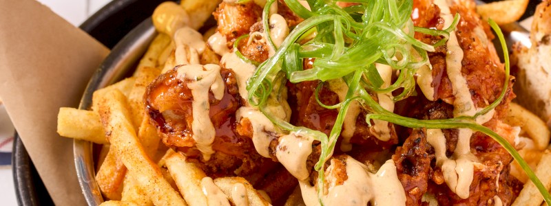 THE BASES LOADED - Original mac, Nashville hot chicken strips, Cajun fries, and sriracha aioli.