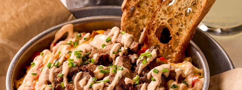 THE PHILLY MAC - Shredded mozzarella and provolone blend,
Philly steak, grilled onions, and bell peppers.