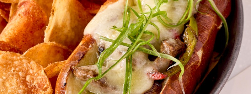 PHILLY SANDWICH - Pretzel hoagie, sliced steak, grilled onions, bell
peppers, and sliced white Cheddar.