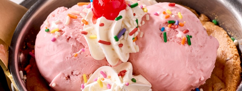 STRAWBERRY SHORTCAKE SKILLET COOKIE - Strawberry shortcake cookie skillet, strawberry
ice cream, whipped topping, and strawberry sauce.