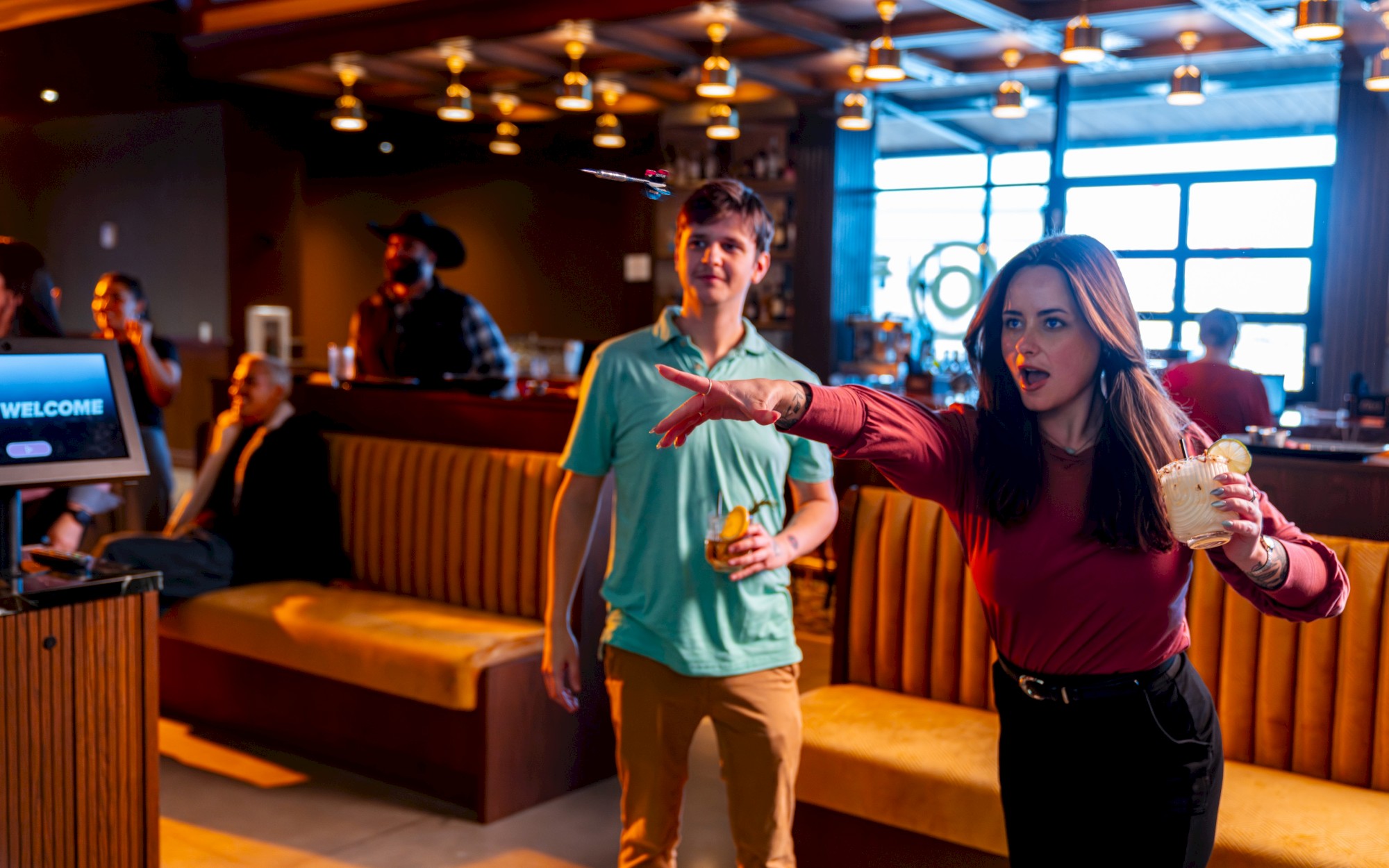 Craft cocktails and games at a hidden speakeasy-style bar at Bullseye at OKANA Resort in OKC, where guests enjoy darts, axe throwing, and drinks.