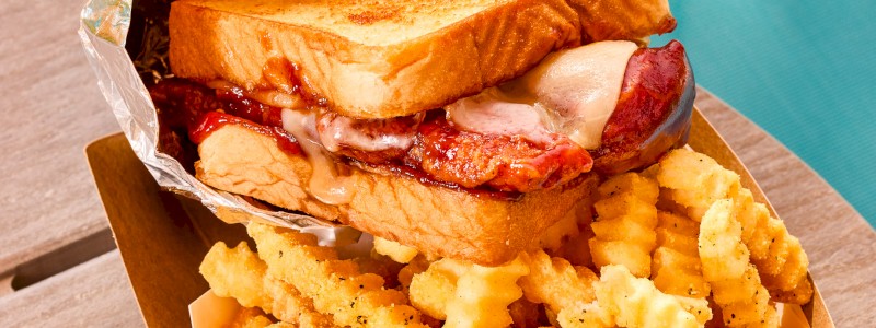 BBQ TENDIES SANDWICH - Three breaded chicken tendies with white Cheddar and BBQ sauce on Texas toast. Served with fries