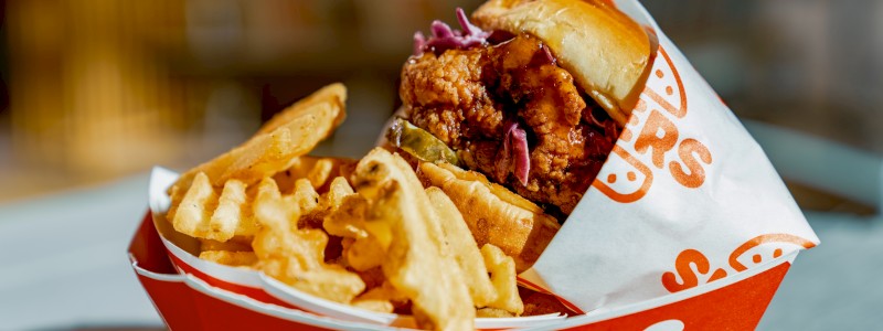 SWEET HEAT - Breaded chicken breast, Sliders’ slaw, house pickle, and hot honey,
served with waffle fries
